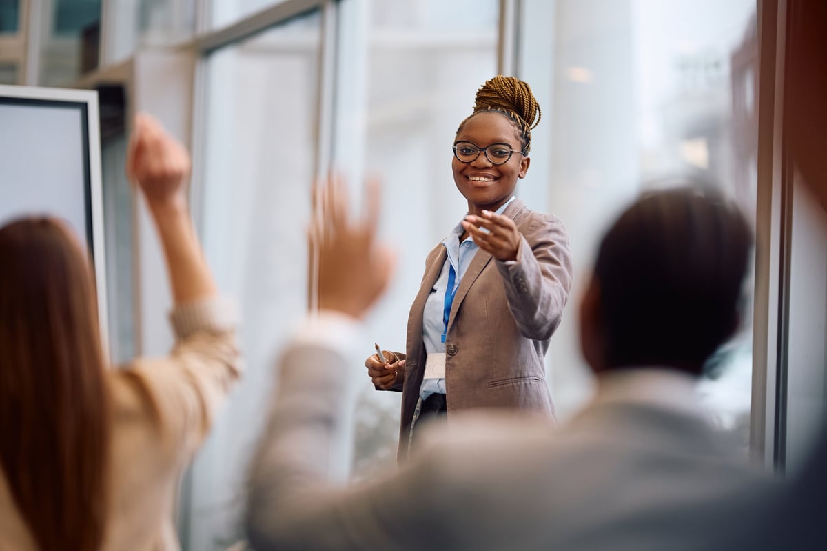 Business leader addressing colleagues during a conference in a boardroom.